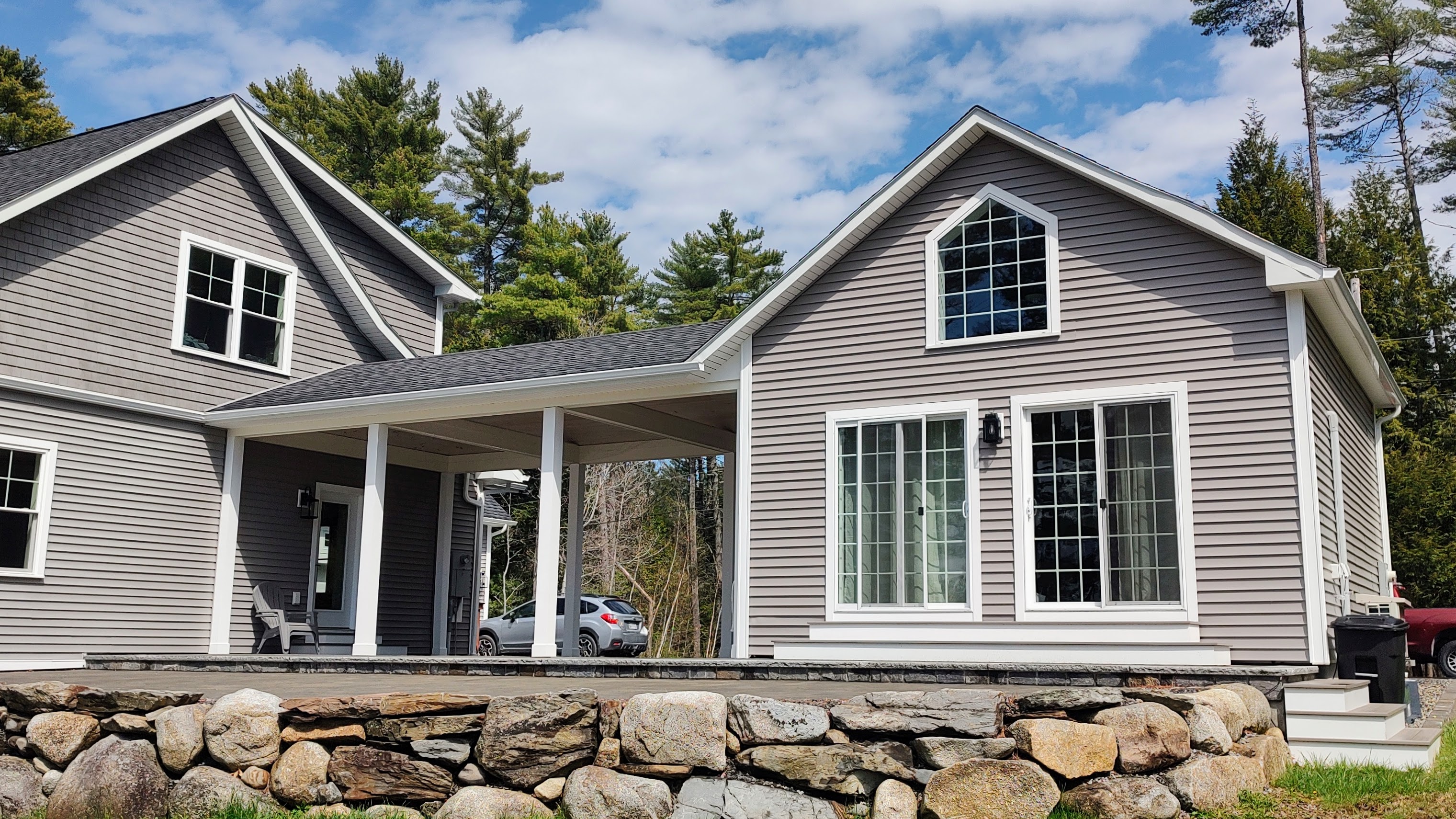 The Loon Loft cottage and the main house behind it on a clear spring day