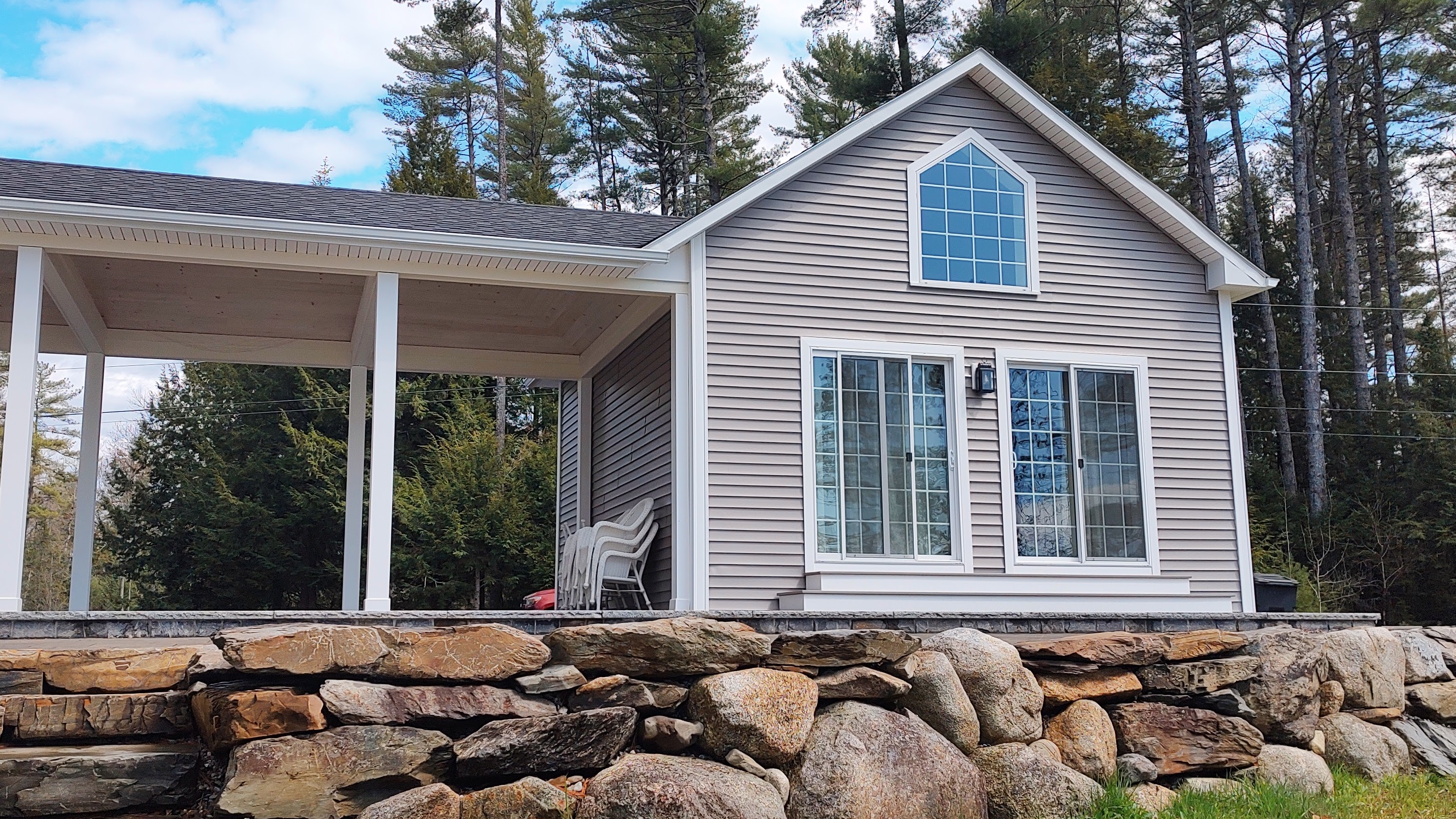 The cottage from the lake side, with the cathedral window above the sliding doors