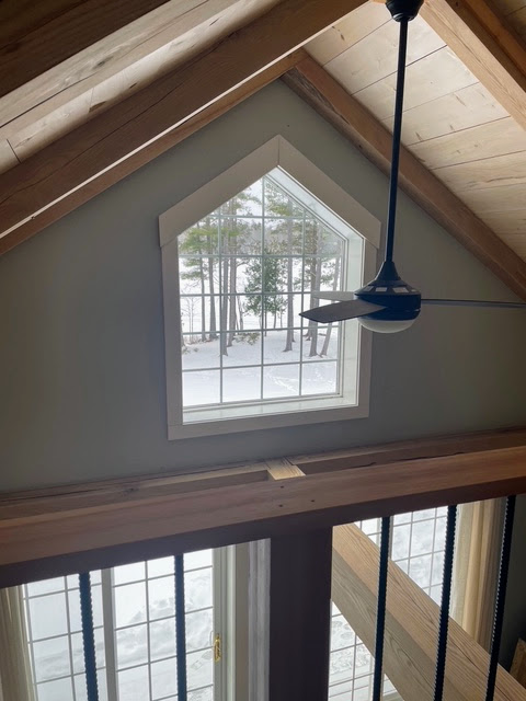 Vaulted pine ceiling and the cathedral window above the loft