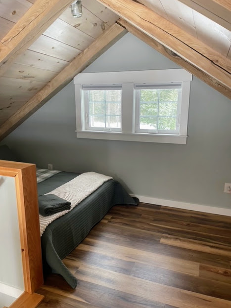 Sleeping loft with reading nook and pond-side window