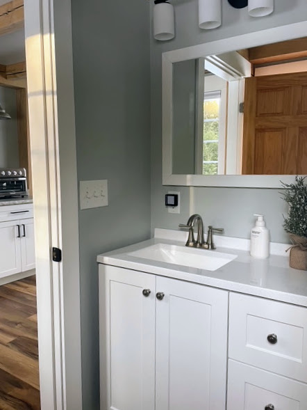 Bathroom vanity with white cabinetry
