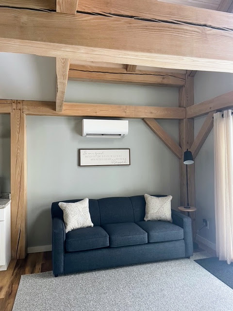Sleeper sofa under exposed post-and-beam timbers