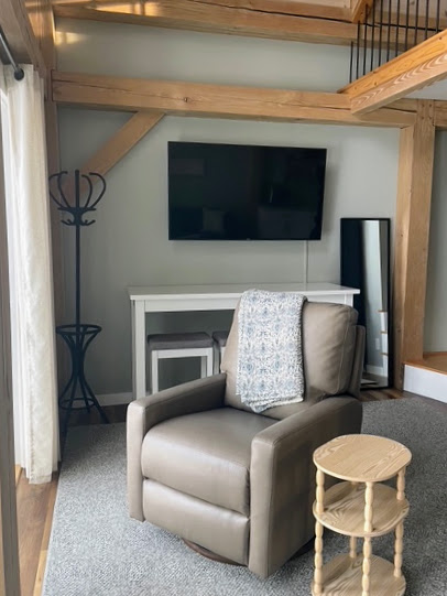 Reclining swivel chair with the wall-mounted television