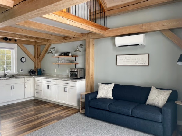 Open kitchen, sleeper sofa, and the sleeping loft above