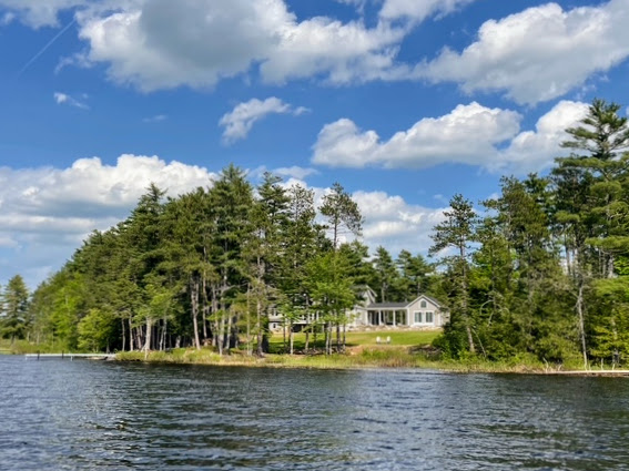 The cottage seen from the water on a summer afternoon